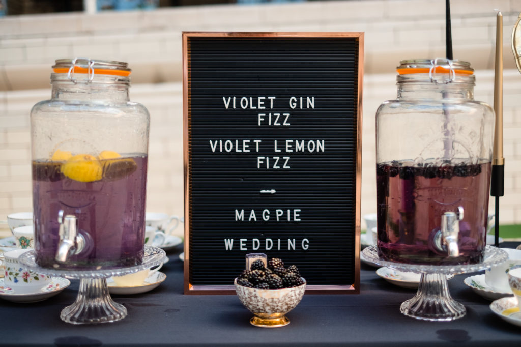 A Black, Gold & Purple Wedding at Victoria Baths with Vintage Embroidered Napkins and purple gin cocktails