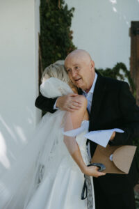 Bride Kayla and her Dad on the morning of her wedding with personalised embroidered handkerchief